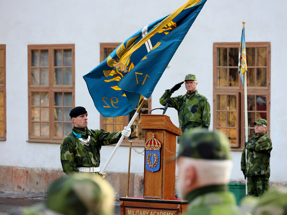 The King salutes Karlberg Military Academy's new standard during a ceremony outside Karlberg Palace in Solna.