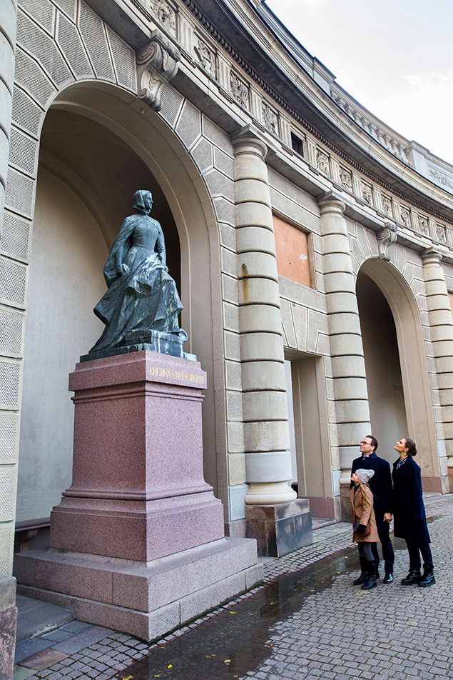 Kronprinsessparet och Prinsessan Estelle vid statyn av Kristina Gyllenstierna. 